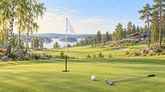 Valoisa kuvitus suomalaisesta golfkentästä. Viheriö, lippu, golfpallo ja maila koivu- ja mäntymetsän reunalla.